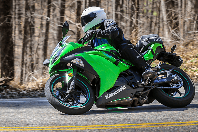 David riding a green Kawasaki motorcycle on the Tail of the Dragon